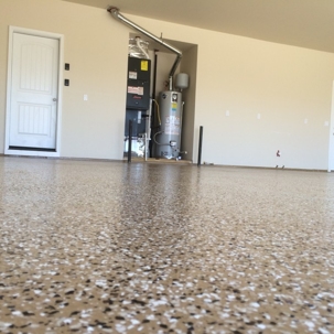 The floor has a speckled appearance with various shades of brown